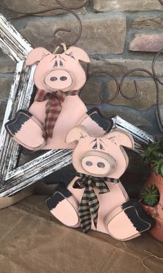 two teddy bears are sitting next to a potted plant and a star shaped mirror