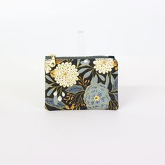 Explore the practicality of our Dawn Garden Coin Pouch, a compact solution for your coins and small items. This coin pouch combines style and functionality, making it a perfect mini wallet or accessory holder. The unique design adds a sophisticated touch to your daily routine. Imagine easily finding your small essentials in this stylish pouch. Order now and keep your belongings neatly organized! Accessory Holder, Accessories Holder, Market Tote, Mini Wallet, Coin Pouch, Zip Pouch, Small Items, Wrist Strap, Daily Routine