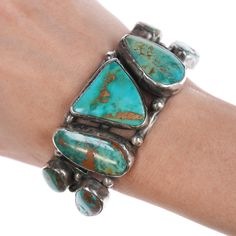 6 3/8" Vintage Royston Turquoise Native American Silver bracelet 1.25" or 33 mm
wide in center, weight and other measurements in pics, no issues, unmarked or
marked as shown. If a mark isn't shown then it isn't marked..

All precious metals are tested and guaranteed, any Native American jewelry
referred to as Silver or Sterling is guaranteed to be a minimum of 90% (coin)
silver and possibly higher content. Anything marked is guaranteed to be what
it's marked, most bracelets are photographed on a 6" wrist (non hairy), rings
photographed on the appropriate sized finger when possible. With bracelets if
the measurement is not given in the description then inside circumference is
shown where the metal meets the number on the the cloth tape measure. Turquoise Patina Bracelet, Turquoise Patina Bracelet Jewelry, Turquoise Chrysocolla Bracelet, Vintage Native American Jewelry, Turquoise Jewelry Native American, Cloth Tape, Royston Turquoise, Vintage Turquoise, American Jewelry