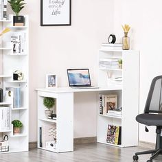 a white desk with a laptop on it in front of a bookcase and bookshelf