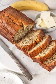 sliced loaf of banana bread with butter on the side