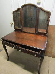 an old desk with a mirror on top