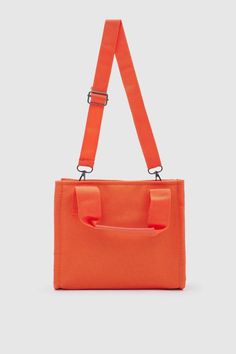 Introducing the "Canvas Fabric Orange Crossbody Bag" from Lunarity Garage – a vibrant and stylish accessory that combines the durability of canvas fabric with a pop of orange color. Crafted with meticulous attention to detail, this bag offers both fashion and functionality to suit your everyday needs. Make a bold statement with the Canvas Fabric Orange Crossbody Bag – a perfect blend of durability and trendiness. The vibrant orange color adds a touch of energy and excitement, making it a versati Trendy Orange Large Capacity Satchel, Trendy Large Capacity Orange Satchel, Red Canvas Shoulder Bag With Zipper, Red Canvas Shoulder Bag With Zipper Closure, Large Capacity Orange Shoulder Bag For School, Large Capacity Orange Pouch Shoulder Bag, Functional Canvas Crossbody Bag For On-the-go, Trendy Orange Shoulder Bag For School, Orange Crossbody School Bag