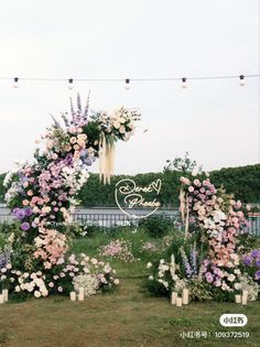 an outdoor ceremony setup with flowers and candles