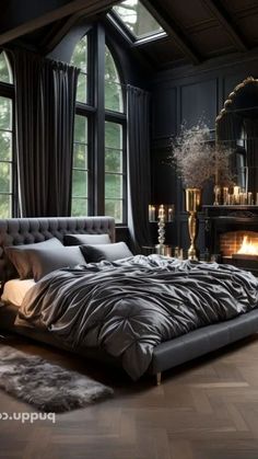 a large bed sitting next to a fireplace in a room with black walls and wooden floors