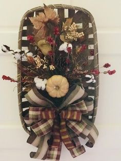 a fall wreath hanging on the side of a door