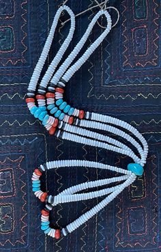 This is a stunning and gorgeous handmade Necklace from Santa Domingo pueblo, by artist, Maria Aguilar. It was made in the 1990s and was a special gift! I really hate to sell it truthfully! All the white beads are handmade clamshell. The one big turquoise bead is realtor place. There are some spiny oyster Heishi. Not sure what the black is. Some of the beads are faux. I will be back with measurements. It's a relatively long necklace, very striking! A beautiful work of Santo Domingo vintage art jewelry! White Southwestern Turquoise Necklace Gift, Southwestern White Turquoise Necklace Gift, Southwestern Style White Turquoise Necklace As Gift, Southwestern Style White Turquoise Necklace Gift, Southwestern Style White Beaded Necklace With Large Beads, Vintage White Hand-strung Necklaces, Traditional White Single Strand Beaded Necklace, White Southwestern Hand-strung Necklaces, Handmade Southwestern White Necklace