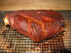 a large piece of meat sitting on top of a grill