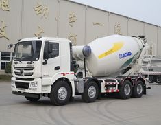 a cement truck parked in front of a building