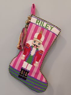 a christmas stocking ornament hanging on a wall