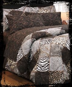 a leopard print comforter set on a bed