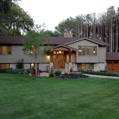 a large house with lots of trees in the front yard and grass on the side