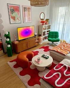 a living room filled with furniture and a flat screen tv on top of a wooden stand