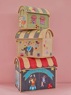 three cardboard boxes stacked on top of each other with an elephant and circus scene painted on them