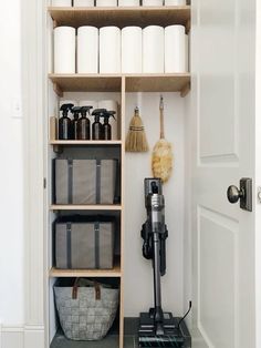 the shelves in this bathroom are filled with cleaning supplies