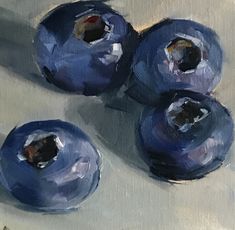 three blueberries sitting on top of a table