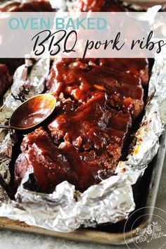 oven baked bbq pork ribs in foil with sauce on top and title overlay