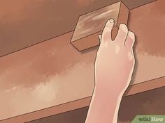 a person is painting the ceiling with brown paint and a wooden box on top of it