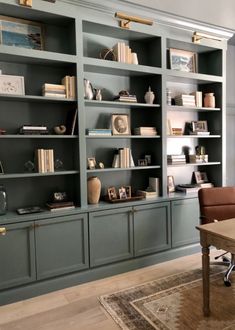 a living room filled with lots of bookshelves next to a dining room table