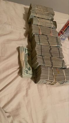 stacks of money sitting on top of a bed