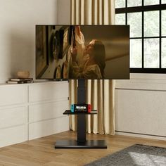 a flat screen tv sitting on top of a wooden floor