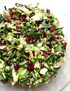 a white plate topped with green and red food