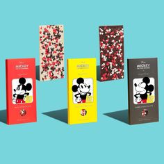 three mickey mouse chocolate bars are shown on a blue background