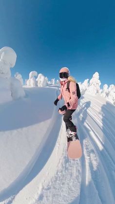 a person riding a snow board on a snowy surface