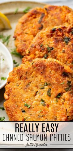 two crab cakes on a plate with lemon wedges next to it and the words, really easy canned salmon patties