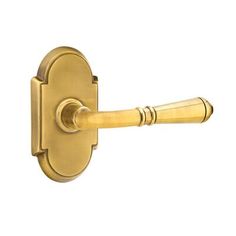 an image of a door handle on a gold colored doorknobl with a white background