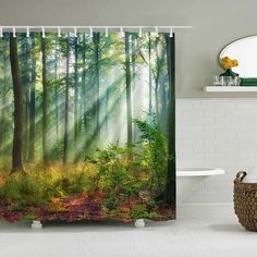 a bathroom with a shower curtain that has a forest scene on it