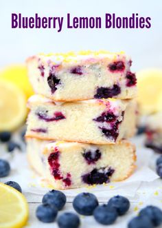 blueberry lemon blondies stacked on top of each other with lemons and blueberries around them