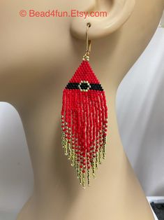 a close up of a mannequin's head wearing red beaded earrings