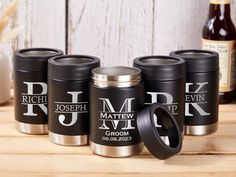 four personalized stainless steel travel mugs on a table