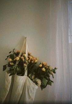 flowers in a bag hanging on the wall