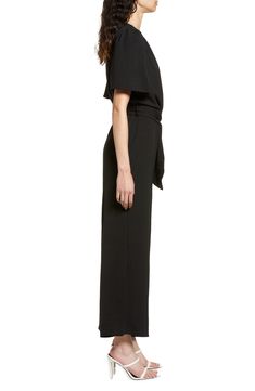 An updated alternative to classic officewear, this sleek jumpsuit features a flattering surplice neck and waist sash for an extra touch of elegance. 56" length Front button closure Surplice V-neck Short sleeves Removable tie belt Partially lined 100% polyester Hand wash, line dry Made in the USA of imported fabric Women's Clothing Sleek V-neck Jumpsuits And Rompers For Work, Elegant Belted Solid Jumpsuits And Rompers, Elegant Jumpsuits With Belted Cuffs, Chic Belted Jumpsuits And Rompers For Formal Occasions, Chic Belted Jumpsuits And Rompers For Formal Events, Chic Formal Belted Jumpsuits And Rompers, Formal Solid Belted Jumpsuit, Elegant Belted Pantsuit For Evening, Black Belted Jumpsuits And Rompers For Evening