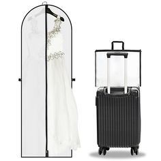 a white dress and black suitcase next to a garment rack with a bride's gown hanging on it