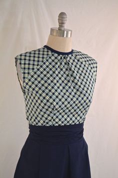 a dress on a mannequin with a blue and white checkered top over it