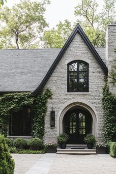 the front entrance to a house with ivy growing all over it