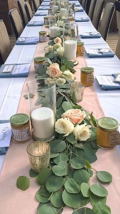 a long table with candles and flowers on it