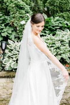 a woman in a white wedding dress and veil