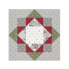 a quilted square with red, green and white designs on it's sides