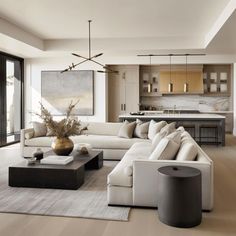 a living room filled with lots of furniture next to a kitchen and dining room table