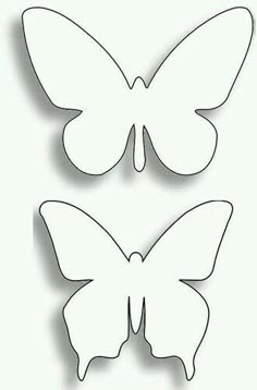 two butterflies cut out of paper on a white background