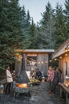 a group of people standing around a fire pit