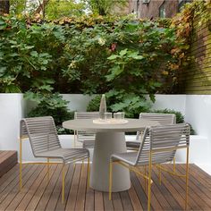 an outdoor table with four chairs around it