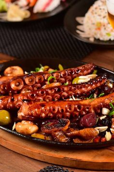 an octopus platter with olives and other food items