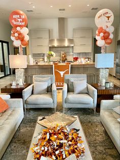 a living room filled with furniture and balloons