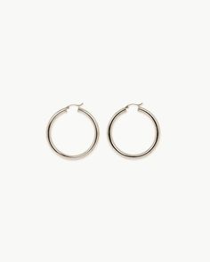 Deliver bold and gold. Our 14k white gold hollow Medium Tube Hoops attain the look of a thick, oversized hoop without fatiguing your ears. With a substantial width of 4mm and a secure lever closure, these eye-catching hoops won’t be exiting your ears any time soon. Sold as a pair. Also available in Small and Large. Luxury White Gold Hoop Earrings With Shiny Finish, Silver Hoop Earrings Tarnish Resistant For Everyday Luxury, Modern Silver Hoop Earrings For Everyday Luxury, Classic Tarnish Resistant White Gold Hoop Earrings, Classic White Gold Tarnish Resistant Hoop Earrings, Classic White Gold Tarnish-resistant Hoop Earrings, Silver Luxury Hoop Earrings, Luxury Hoop Earrings With Shiny Finish For Everyday, Silver Small Hoop Earrings For Everyday Luxury