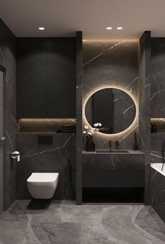 a bathroom with two sinks, a toilet and a large mirror in the middle of it